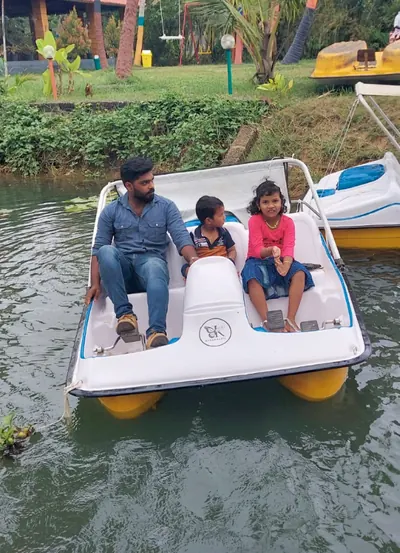 Family enjoying a pedal boat ride in Poovar