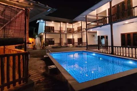 Island view cottage with swimming pool in Poovar at night