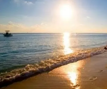 Sunset over the sea at Poovar beach seen from a boat
